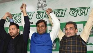 Patna: Mukesh Sahni, National President of the Vikasheel Insaan Party (VIP) raises hands with RJD's leader Tejashwi Yadav and Rashtriya Lok Samta Party (RLSP) leader Upendra Kushwaha after joining the grand alliance during a press conference in Patna.(HT File)