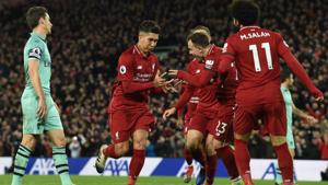 Liverpool's Brazilian midfielder Roberto Firmino (2L) celebrates shooting from the penalty spot to score his team's fifth goal during the English Premier League football match between Liverpool and Arsenal at Anfield in Liverpool(AFP) Liverpool's Brazilian midfielder Roberto Firmino (2L) celebrates shooting from the penalty spot to score his team's fifth goal during the English Premier League football match between Liverpool and Arsenal at Anfield in Liverpool(AFP)