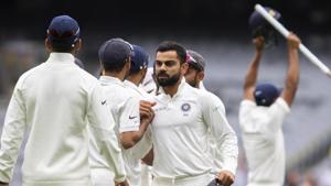 Virat Kohli, center, congratulates his teammates after India defeated Australia.(AP) Virat Kohli, center, congratulates his teammates after India defeated Australia.(AP)