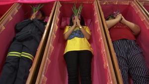 People like in coffins to ring in the new year in a bizarre ritual in Thailand.(AP) People like in coffins to ring in the new year in a bizarre ritual in Thailand.(AP)