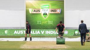 Melbourne cricket ground curators attend to the pitch before the start of play on day four of the third Test.(AP) Melbourne cricket ground curators attend to the pitch before the start of play on day four of the third Test.(AP)