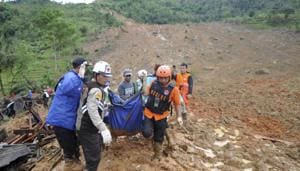 Rescuers carry the body of a landslide victim in Sirnaresmi, West Java, Indonesia, Tuesday, Jan. 1, 2019. The landslide triggered by torrential rain has killed a number of people and left dozens of others missing on Indonesia's main island of Java.(AP) Rescuers carry the body of a landslide victim in Sirnaresmi, West Java, Indonesia, Tuesday, Jan. 1, 2019. The landslide triggered by torrential rain has killed a number of people and left dozens of others missing on Indonesia's main island of Java.(AP)