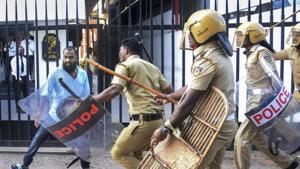 Policemen chase away a protester during a protest against the entry of two women to the Sabarimala temple, in Thiruvananthapuram on Wednesday.(PTI) Policemen chase away a protester during a protest against the entry of two women to the Sabarimala temple, in Thiruvananthapuram on Wednesday.(PTI)