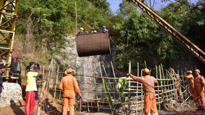 NDRF personnel gather around a crane as Navy divers are lifted with a pulley during rescue operations to help 15 miners trapped by flooding in an illegal coal mine in Ksan village in Meghalaya's East Jaintia Hills district.(AFP File Photo) NDRF personnel gather around a crane as Navy divers are lifted with a pulley during rescue operations to help 15 miners trapped by flooding in an illegal coal mine in Ksan village in Meghalaya's East Jaintia Hills district.(AFP File Photo)