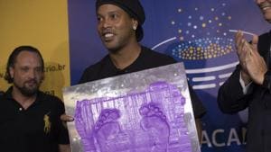 Barcelona legend Ronaldinho holds a print of his feet that will be placed at the Maracana stadium.(AP) Barcelona legend Ronaldinho holds a print of his feet that will be placed at the Maracana stadium.(AP)