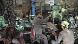 Workers make gear parts for cranes inside a workshop in Mumbai.(Reuters) Workers make gear parts for cranes inside a workshop in Mumbai.(Reuters)