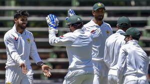 Pakistan's bowler Shadab Khan, left, celebrates with his captain Pakistan's wicket keeper Sarfraz Ahmed after the wicket of South Africa's batsman Hashim Amla on day one of the third cricket Test match(AP)