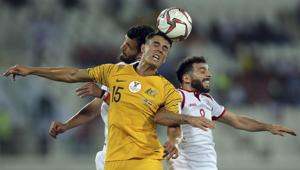Australia's midfielder Christopher Ikonomid, center, jumps for the ball with Syria's midfielder Mahmoud al Maowas, right, during the AFC Asian Cup match.(AP) Australia's midfielder Christopher Ikonomid, center, jumps for the ball with Syria's midfielder Mahmoud al Maowas, right, during the AFC Asian Cup match.(AP)