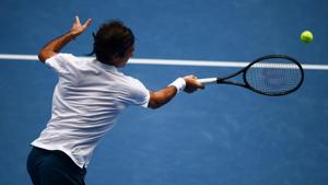 Switzerland's Roger Federer hits a return against Britain's Daniel Evans during their men's singles match on day three of the Australian Open tennis tournament in Melbourne(AFP) Switzerland's Roger Federer hits a return against Britain's Daniel Evans during their men's singles match on day three of the Australian Open tennis tournament in Melbourne(AFP)
