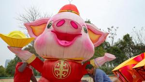Workers set up a decoration to mark the upcoming Lunar New Year of the Pig in Nantong, China's eastern Jiangsu province (File Photo)(AFP) Workers set up a decoration to mark the upcoming Lunar New Year of the Pig in Nantong, China's eastern Jiangsu province (File Photo)(AFP)