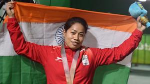 Sanjita Chanu poses with the tricolour for a photo after winning gold in the women's 53kg Weightlifting event.(PTI) Sanjita Chanu poses with the tricolour for a photo after winning gold in the women's 53kg Weightlifting event.(PTI)