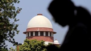 A woman checks her mobile phone inside the premises of the Supreme Court in New Delhi.(REUTERS) A woman checks her mobile phone inside the premises of the Supreme Court in New Delhi.(REUTERS)