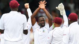 Kemar Roach (C) of West Indies celebrates the dismissal of Ben Stokes of England.(AFP)