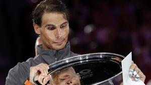 Spain's Rafael Nadal poses with his trophy after losing the Australian Open final against Serbia's Novak Djokovic.(REUTERS)