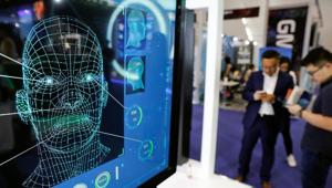 File photo of visitors check their phones behind the screen advertising facial recognition software at an exhibition in Beijing. The Delhi Police has adopted a facial recognition software to solve missing children cases.(Reuters / Representative Image) File photo of visitors check their phones behind the screen advertising facial recognition software at an exhibition in Beijing. The Delhi Police has adopted a facial recognition software to solve missing children cases.(Reuters / Representative Image)