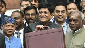Finance Minister Piyush Goyal (C) displays a briefcase containing the Union budget to be presented at the Parliament today, outside his North Block office in New Delhi, Friday, 1 Feb, 2019.(PTI) Finance Minister Piyush Goyal (C) displays a briefcase containing the Union budget to be presented at the Parliament today, outside his North Block office in New Delhi, Friday, 1 Feb, 2019.(PTI)