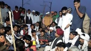 K S Bainsla along with Gujjar supporters sit on tracks at Malarna railway station to block railway route in Sawai Madhopur on Friday.(HT Photo) K S Bainsla along with Gujjar supporters sit on tracks at Malarna railway station to block railway route in Sawai Madhopur on Friday.(HT Photo)