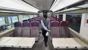 A worker cleans the interior of T-18 train which has diffused lighting, automatic doors and footsteps beside GPS-based Passenger Information System,.(Burhaan Kinu/HT PHOTO) A worker cleans the interior of T-18 train which has diffused lighting, automatic doors and footsteps beside GPS-based Passenger Information System,.(Burhaan Kinu/HT PHOTO)
