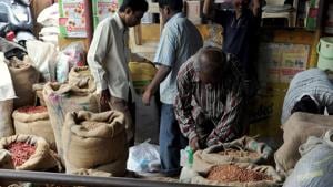 Workers and customers look through the goods at a wholesale food grain and commodities shop in the Agricultural Product Marketing Committee (APMC) Yard in Bangalore.(AFP file photo) Workers and customers look through the goods at a wholesale food grain and commodities shop in the Agricultural Product Marketing Committee (APMC) Yard in Bangalore.(AFP file photo)