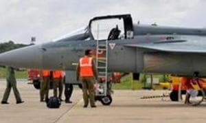 Airport ground staff stand besides Tejas, India's first locally-built Light Combat Aircraft (LCA), before its induction into the Indian Air Force at the Hindustan Aeronautics Limited (HAL) Airport in Bengaluru, India, July 1, 2016.(REUTERS) Airport ground staff stand besides Tejas, India's first locally-built Light Combat Aircraft (LCA), before its induction into the Indian Air Force at the Hindustan Aeronautics Limited (HAL) Airport in Bengaluru, India, July 1, 2016.(REUTERS)