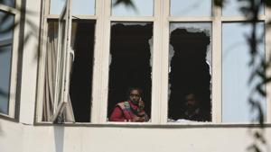 A woman is seen talking over the phone through the broken window after a massive fire broke out at Hotel Arpit Palace, in Karol Bagh in New Delhi, on Tuesday, February 12, 2019.(Biplov Bhuyan/HT Photo) A woman is seen talking over the phone through the broken window after a massive fire broke out at Hotel Arpit Palace, in Karol Bagh in New Delhi, on Tuesday, February 12, 2019.(Biplov Bhuyan/HT Photo)