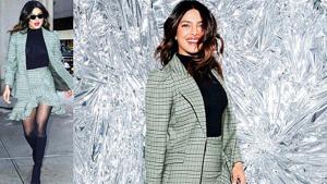 Priyanka Chopra’s plaid suit featured an asymmetric mini skirt, which she teamed with sheer black stockings and boots. (Instagram)