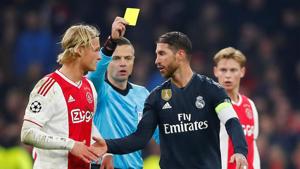 Real Madrid's Sergio Ramos is shown a yellow card by referee Damir Skomina as Ajax's Kasper Dolberg looks on.(REUTERS) Real Madrid's Sergio Ramos is shown a yellow card by referee Damir Skomina as Ajax's Kasper Dolberg looks on.(REUTERS)