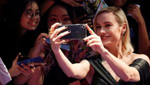Captain Marvel cast member Brie Larson poses for a selfie with fans in Singapore.(REUTERS) Captain Marvel cast member Brie Larson poses for a selfie with fans in Singapore.(REUTERS)