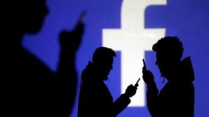Silhouettes of mobile users are seen next to a screen projection of Facebook logo in this picture illustration taken March 28, 2018. Image for representation.(REUTERS FILE PHOTO) Silhouettes of mobile users are seen next to a screen projection of Facebook logo in this picture illustration taken March 28, 2018. Image for representation.(REUTERS FILE PHOTO)