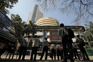 People look at a screen displaying the Sensex results on the facade of the Bombay Stock Exchange (BSE) building in Mumbai.(REUTERS FILE PHOTO) People look at a screen displaying the Sensex results on the facade of the Bombay Stock Exchange (BSE) building in Mumbai.(REUTERS FILE PHOTO)