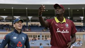 West Indies' captain Jason Holder flips the coin as England's captain Eoin Morgan looks on prior to the third ODI.(AP) West Indies' captain Jason Holder flips the coin as England's captain Eoin Morgan looks on prior to the third ODI.(AP)
