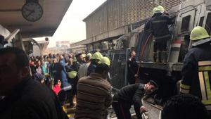 A member of security forces gestures as rescue workers and people gather at the scene after a fire caused deaths and injuries at the main train station in Cairo, Egypt, on February 27.(REUTERS) A member of security forces gestures as rescue workers and people gather at the scene after a fire caused deaths and injuries at the main train station in Cairo, Egypt, on February 27.(REUTERS)