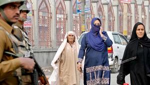 Paramilitary soldiers stand guard as Kashmiri women walk on a street in Srinagar. It is hard to imagine a place in India where a vast majority of people live not having known the simple pleasures of taking a stroll down a road. But this is the reality for most women in Kashmir who have lived for decades in abnormal conditions(AP) Paramilitary soldiers stand guard as Kashmiri women walk on a street in Srinagar. It is hard to imagine a place in India where a vast majority of people live not having known the simple pleasures of taking a stroll down a road. But this is the reality for most women in Kashmir who have lived for decades in abnormal conditions(AP)