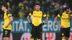 (L-R) Dortmund's Portuguese defender Raphael Guerreiro, Dortmund's English midfielder Jadon Sancho and Dortmund's Spanish forward Paco Alcacer react after the German first division Bundesliga football match.(AFP)