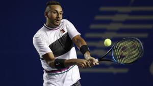 Australia's Nick Kyrgios hits a return to John Isner, of the United States.(AP) Australia's Nick Kyrgios hits a return to John Isner, of the United States.(AP)