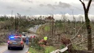 People clear fallen trees and debris on a road following a tornado in Beauregard, Alabama, U.S.(Reuters) People clear fallen trees and debris on a road following a tornado in Beauregard, Alabama, U.S.(Reuters)