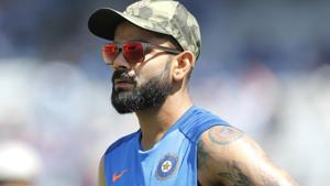 Virat Kohli sports a camouflage cap before the start of the third ODI between India and Australia in Ranchi.(AP) Virat Kohli sports a camouflage cap before the start of the third ODI between India and Australia in Ranchi.(AP)