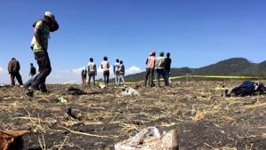 People walk at the scene of the Ethiopian Airlines Flight ET 302 plane crash, near the town of Bishoftu, southeast of Addis Ababa, Ethiopia on March 10.(REUTERS) People walk at the scene of the Ethiopian Airlines Flight ET 302 plane crash, near the town of Bishoftu, southeast of Addis Ababa, Ethiopia on March 10.(REUTERS)