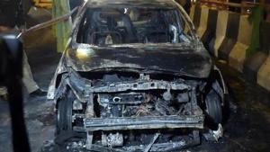 The car that caught fire, resulting the death of three persons, near Akshardham Mandir flyover.(Sushil Kumar/HT PHOTO) The car that caught fire, resulting the death of three persons, near Akshardham Mandir flyover.(Sushil Kumar/HT PHOTO)