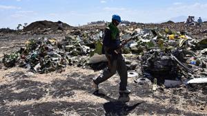 An Oromo man hired to assist forensic investigators walks by a pile of twisted airplane debris at the crash site of an Ethiopian airways operated Boeing 737 MAX aircraft on March 16, 2019 at Hama Quntushele village near Bishoftu in Oromia region.(AFP Photo) An Oromo man hired to assist forensic investigators walks by a pile of twisted airplane debris at the crash site of an Ethiopian airways operated Boeing 737 MAX aircraft on March 16, 2019 at Hama Quntushele village near Bishoftu in Oromia region.(AFP Photo)