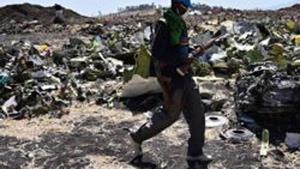 An Oromo man hired to assist forensic investigators walks by a pile of twisted airplane debris at the crash site of an Ethiopian airways operated Boeing 737 MAX aircraft on March 16, 2019 at Hama Quntushele village near Bishoftu in Oromia region. - A French investigation into the March 10 Nairobi-bound Ethiopian Airlines Boeing 737 MAX crash that killed 157 passengers and crew opened on March 15 as US aerospace giant Boeing stopped delivering the top-selling aircraft. (Photo by TONY KARUMBA / AFP)(AFP) An Oromo man hired to assist forensic investigators walks by a pile of twisted airplane debris at the crash site of an Ethiopian airways operated Boeing 737 MAX aircraft on March 16, 2019 at Hama Quntushele village near Bishoftu in Oromia region. - A French investigation into the March 10 Nairobi-bound Ethiopian Airlines Boeing 737 MAX crash that killed 157 passengers and crew opened on March 15 as US aerospace giant Boeing stopped delivering the top-selling aircraft. (Photo by TONY KARUMBA / AFP)(AFP)