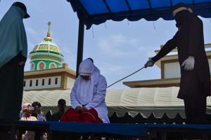 An Indonesian woman is whipped by a member of the Sharia police in public in Banda Aceh on March 20.(AFP Photo) An Indonesian woman is whipped by a member of the Sharia police in public in Banda Aceh on March 20.(AFP Photo)