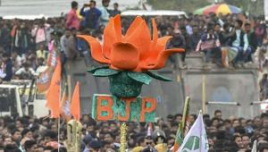 A BJP activist holds a 'lotus' as Prime Minister Narendra Modi addresses 'Save Democracy' rally at Churabhandar, Maynagiri in Jalpaiguri district.(AP File Photo) A BJP activist holds a 'lotus' as Prime Minister Narendra Modi addresses 'Save Democracy' rally at Churabhandar, Maynagiri in Jalpaiguri district.(AP File Photo)