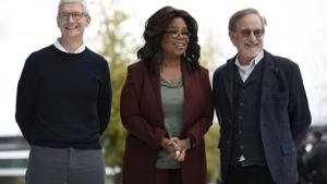 Apple Inc. CEO Tim Cook, Oprah Winfrey and filmmaker Steven Spielberg pose for photos during an Apple product launch event at the Steve Jobs Theater at Apple Park.(AFP) Apple Inc. CEO Tim Cook, Oprah Winfrey and filmmaker Steven Spielberg pose for photos during an Apple product launch event at the Steve Jobs Theater at Apple Park.(AFP)