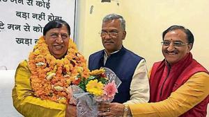 Chief minister Trivendra Singh Rawat (centre) welcomes the acting president of BJP state unit, Naresh Bansal (L), at party state headquarters in Dehradun on Wednesday, March 27, 2019.(Vinay Santosh Kumar / HT Photo) Chief minister Trivendra Singh Rawat (centre) welcomes the acting president of BJP state unit, Naresh Bansal (L), at party state headquarters in Dehradun on Wednesday, March 27, 2019.(Vinay Santosh Kumar / HT Photo)