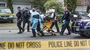 Paramedics and police officers remove a man from where two vehicles collided on Sand Point Way Northeast in Seattle on March 27.(AP Photo) Paramedics and police officers remove a man from where two vehicles collided on Sand Point Way Northeast in Seattle on March 27.(AP Photo)