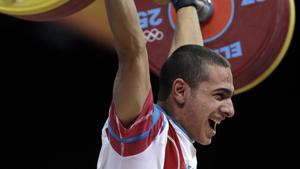File image - Valentin Hristov of Azerbaijan competes during the men's 56-kg weightlifting competition at the 2012 Olympics.(AP) File image - Valentin Hristov of Azerbaijan competes during the men's 56-kg weightlifting competition at the 2012 Olympics.(AP)