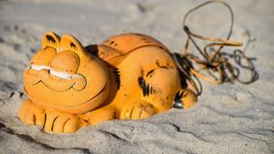 A plastic 'Garfield' phone displayed on the beach in Plouarzel, France, after being collected from a sea cave by environmental activists.(AFP) A plastic 'Garfield' phone displayed on the beach in Plouarzel, France, after being collected from a sea cave by environmental activists.(AFP)
