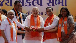 Gujarat Chief Minister Vijay Rupani (2nd from R), Deputy Chief Minister Nitin Patel (3rd from L), State Mayor Bijal Patel (R) and Home Minister Rajnath Singh handover a coconut as a goodluck to BJP National President Amit Shah (C) during his public meeting in Ahmedabad on Saturday.(ANI) Gujarat Chief Minister Vijay Rupani (2nd from R), Deputy Chief Minister Nitin Patel (3rd from L), State Mayor Bijal Patel (R) and Home Minister Rajnath Singh handover a coconut as a goodluck to BJP National President Amit Shah (C) during his public meeting in Ahmedabad on Saturday.(ANI)