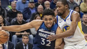 Minnesota Timberwolves center Karl-Anthony Towns (32) drives to the basket past Golden State Warriors forward Kevin Durant (35).(Reuters) Minnesota Timberwolves center Karl-Anthony Towns (32) drives to the basket past Golden State Warriors forward Kevin Durant (35).(Reuters)